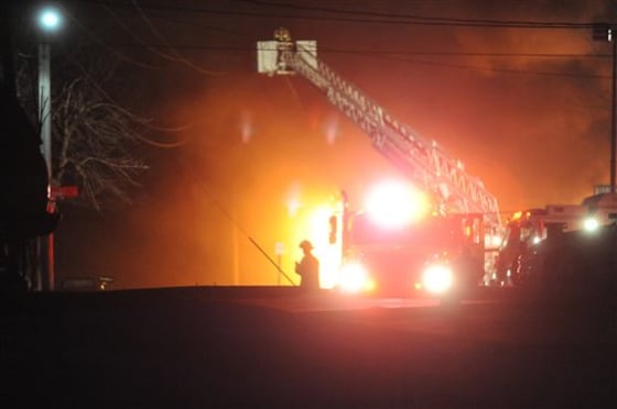 A fire burns at the former Westclox factory complex early Sunday, Jan. 1, in Peru, Ill. The fire began before midnight and was still burning Sunday morning. 